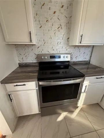 a stove top oven sitting inside of a kitchen