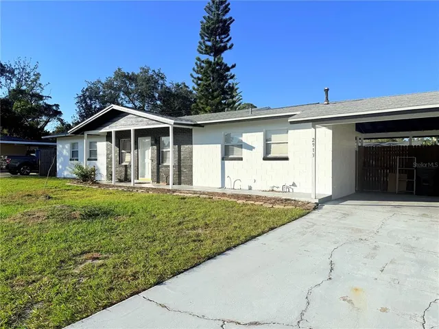 a front view of a house with a garden and yard