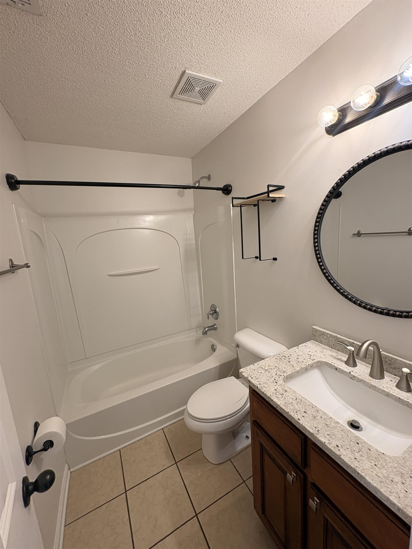 11590 Milton Ridge Cove Arlington, TN 38002 - Photo 13 of 24 Full bath with vanity, a textured ceiling, tub / shower combination, and light tile patterned floors