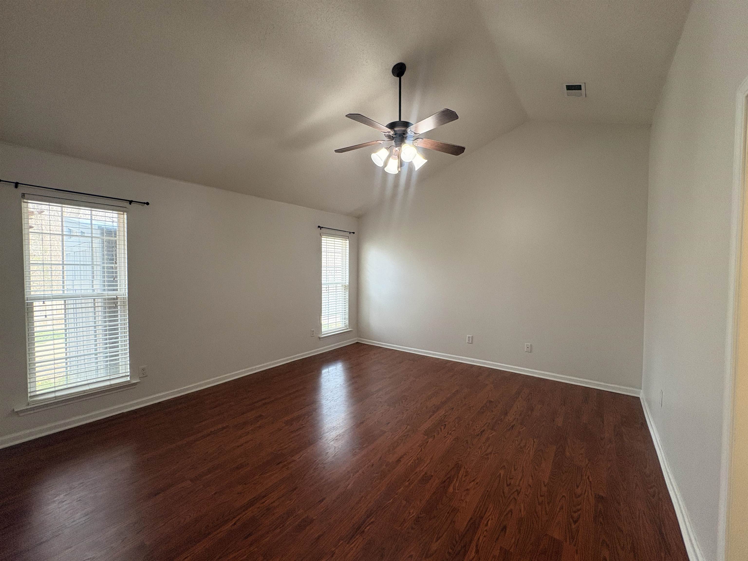 11590 Milton Ridge Cove Arlington, TN 38002 - Photo 17 of 24 Empty room with vaulted ceiling, dark wood-style flooring, and ceiling fan