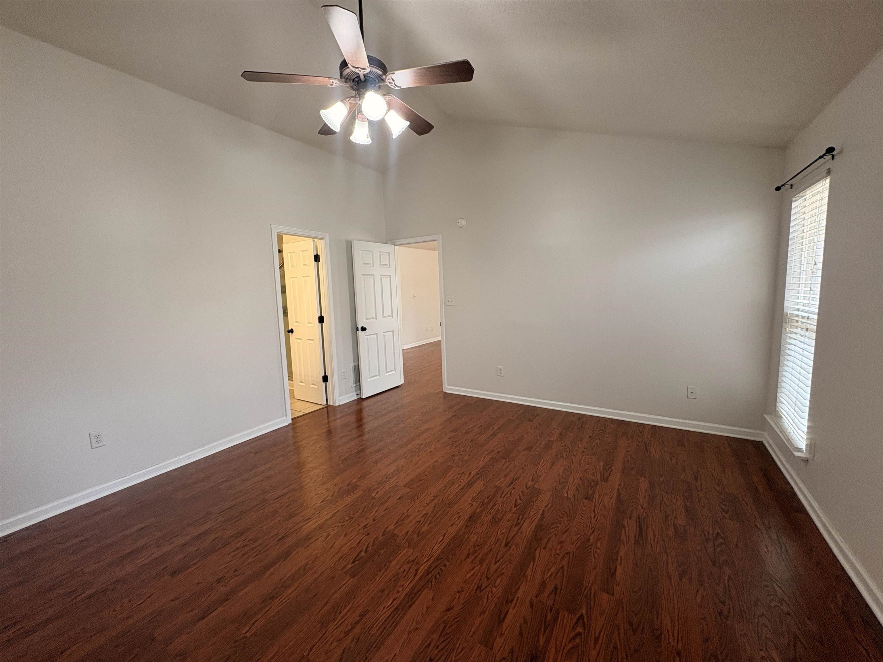 11590 Milton Ridge Cove Arlington, TN 38002 - Photo 18 of 24 Spare room with dark wood-style floors, a ceiling fan, and lofted ceiling