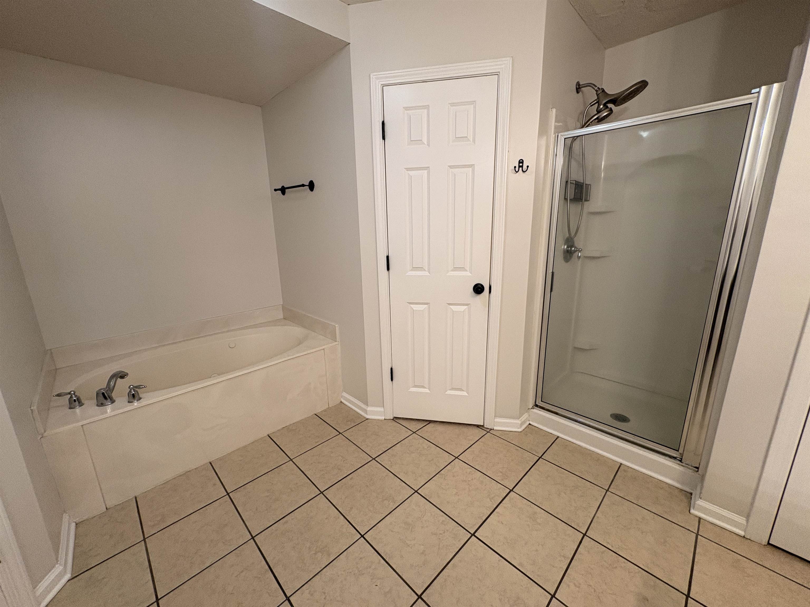 11590 Milton Ridge Cove Arlington, TN 38002 - Photo 20 of 24 Bathroom with a stall shower, a bath, and light tile patterned floors