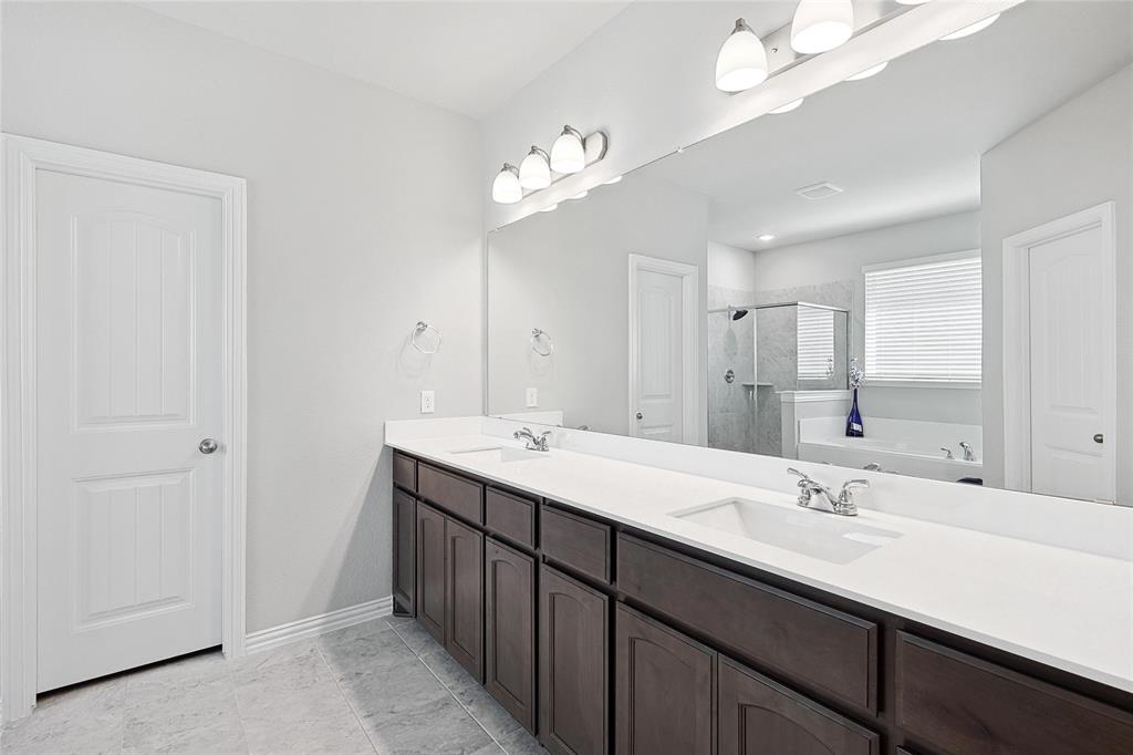 808 Feather Edge Drive Springtown, TX 76082 - Photo 24 of 40 a bathroom with a double vanity sink and a mirror