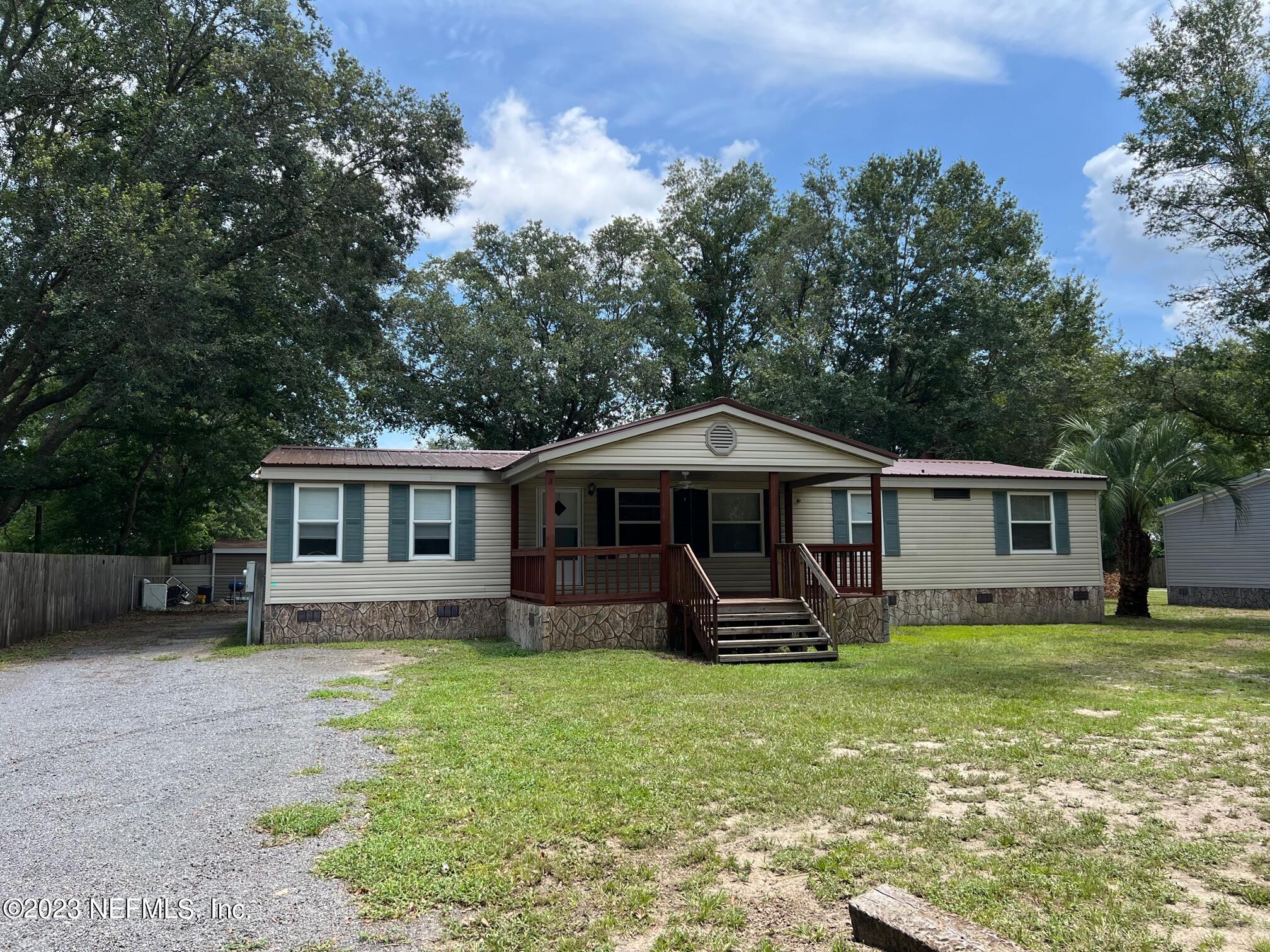 4097 South Wood Road Jacksonville, FL 32234 - Photo 1 of 7 a front view of a house with garden