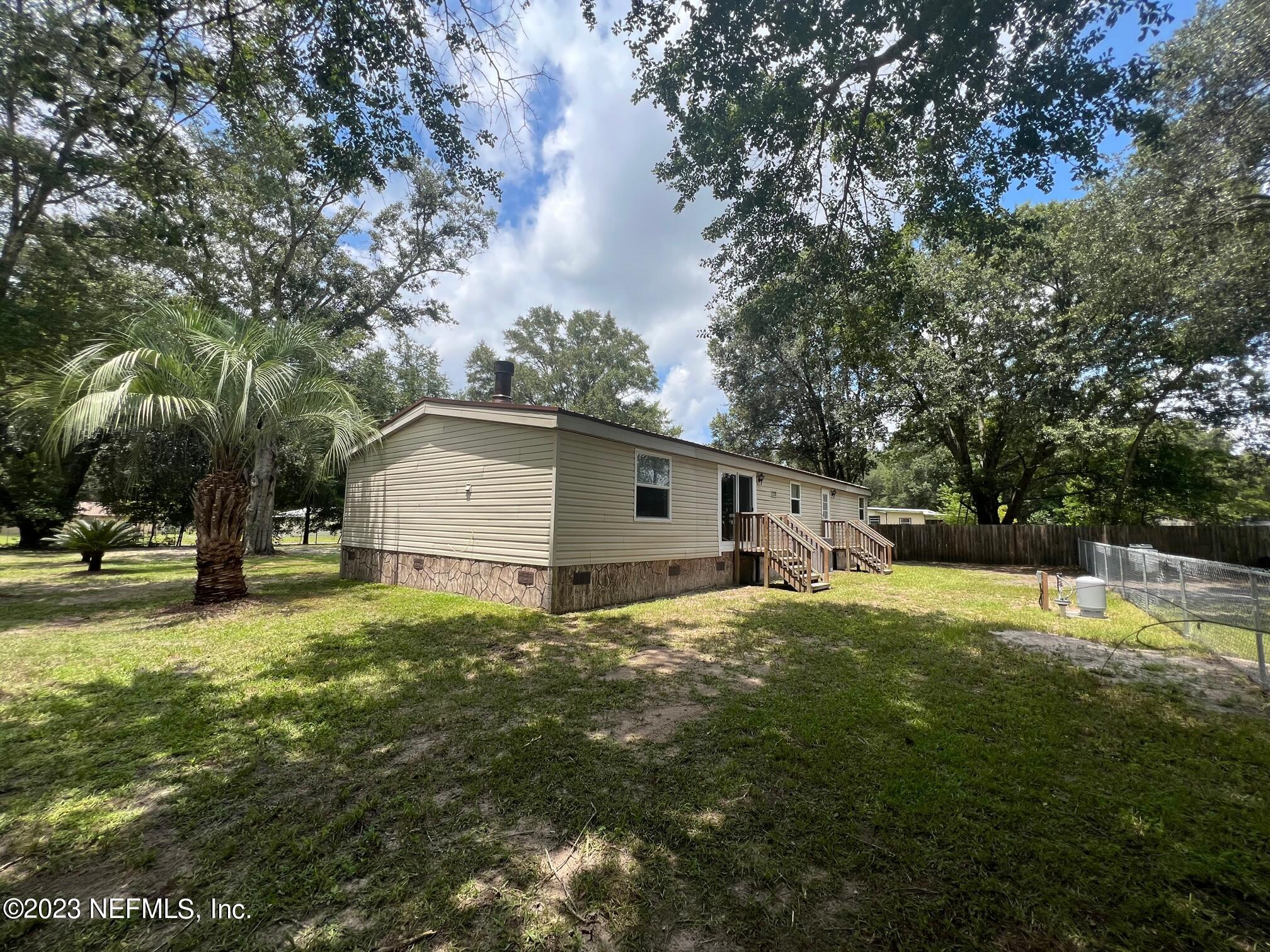 4097 South Wood Road Jacksonville, FL 32234 - Photo 3 of 7 a view of a backyard with large tree