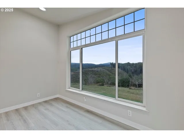 a view of a kitchen with wooden floor and a kitchen