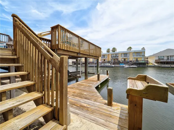 a view of a house with pool and wooden floor