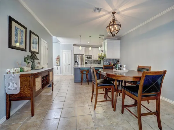 a dining room with a wooden table and chairs