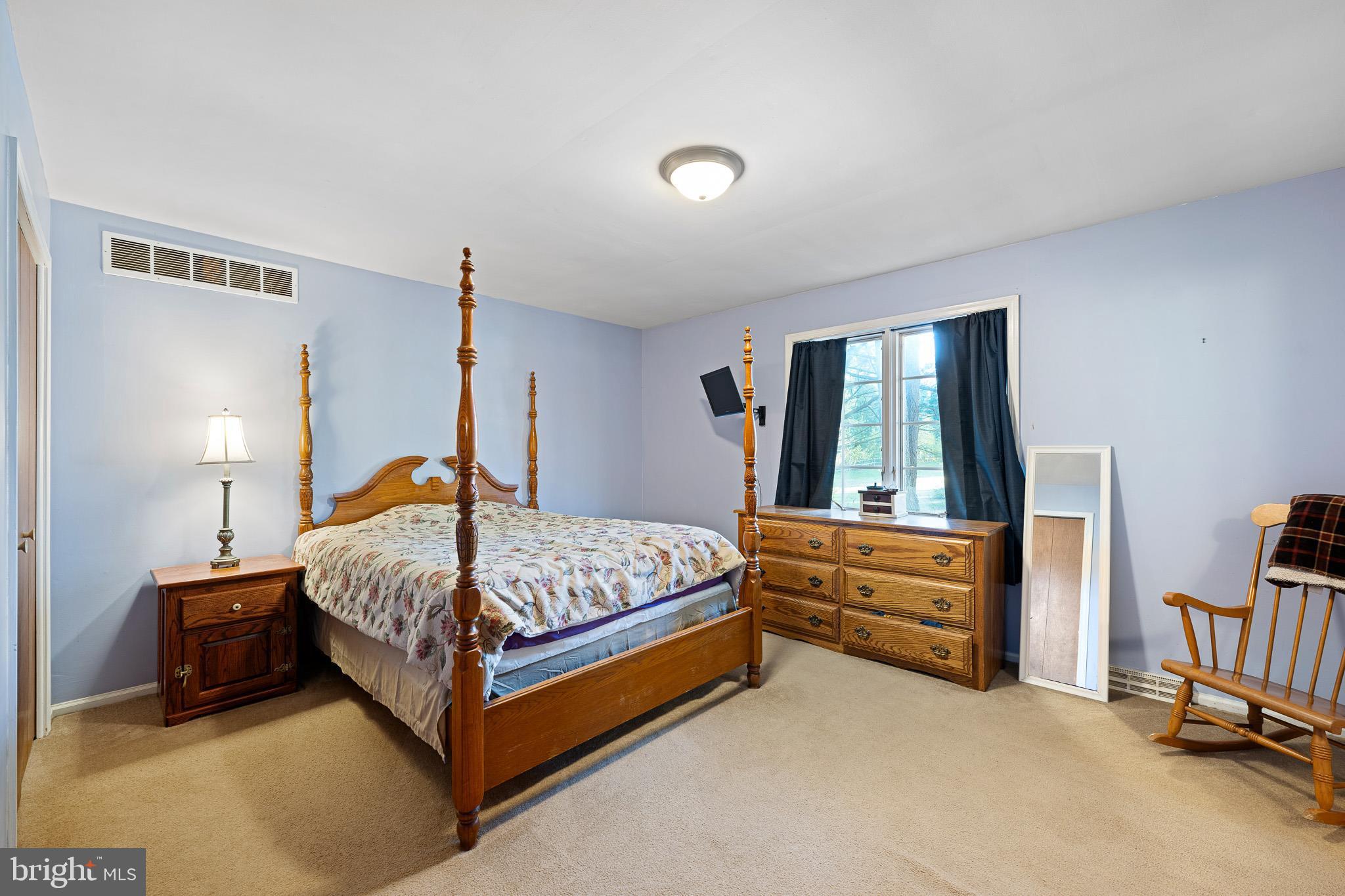 2209 Wheatleys Pond Road Smyrna, DE 19977 - Photo 15 of 39 a bedroom with a bed and a window
