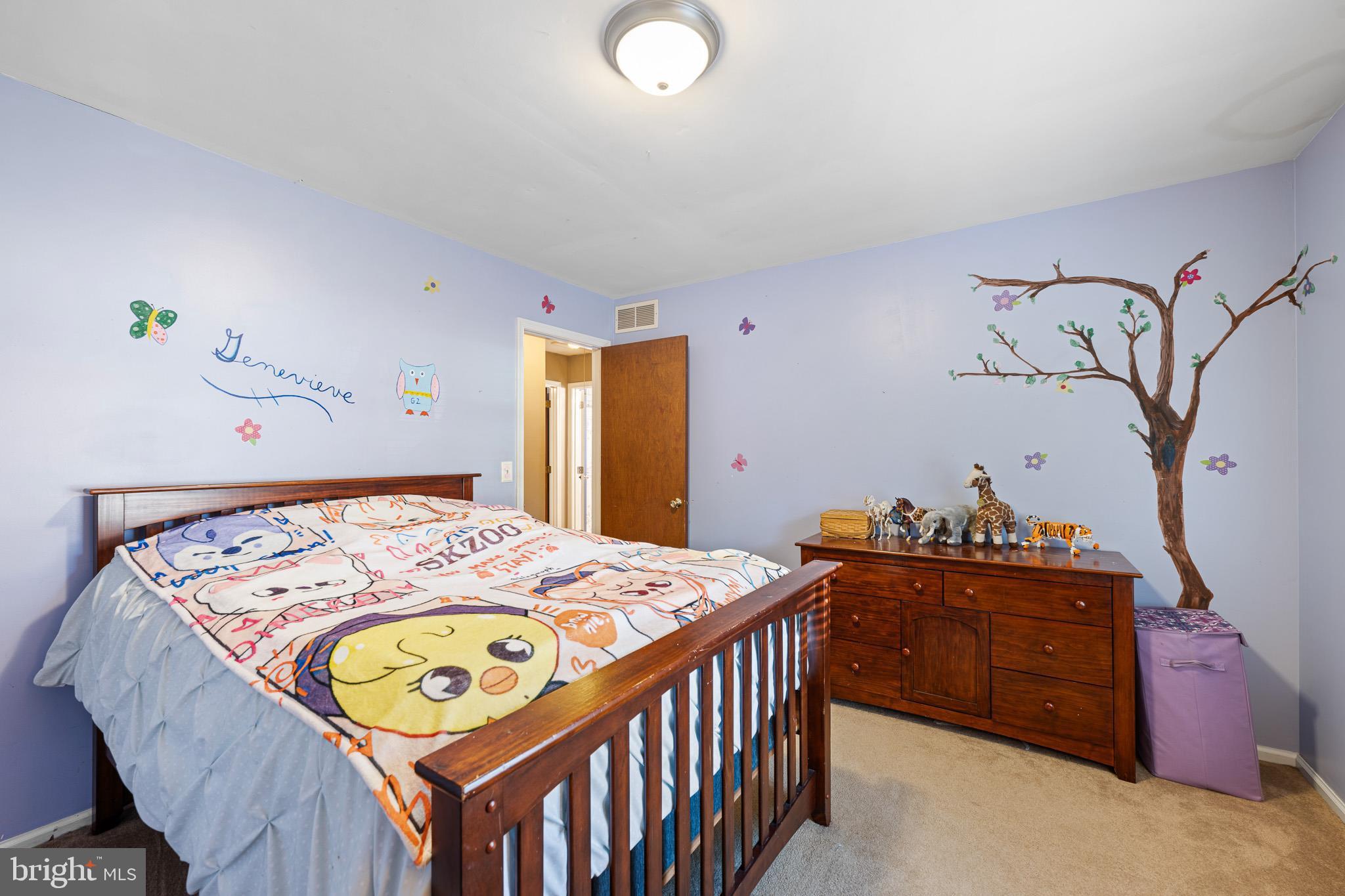 2209 Wheatleys Pond Road Smyrna, DE 19977 - Photo 20 of 39 a bed sitting in a bedroom next to a window