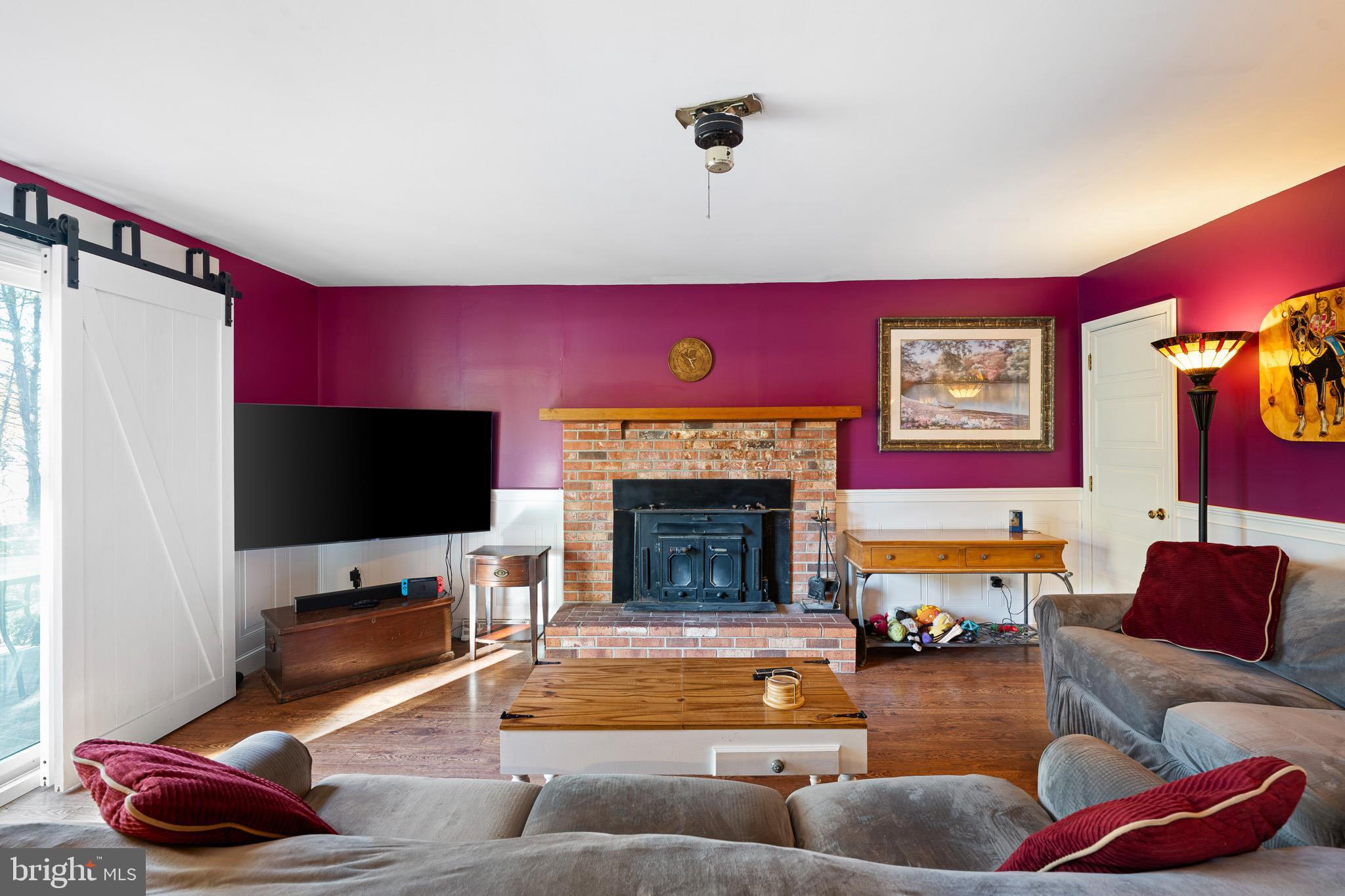 2209 Wheatleys Pond Road Smyrna, DE 19977 - Photo 3 of 39 a living room with furniture and a flat screen tv