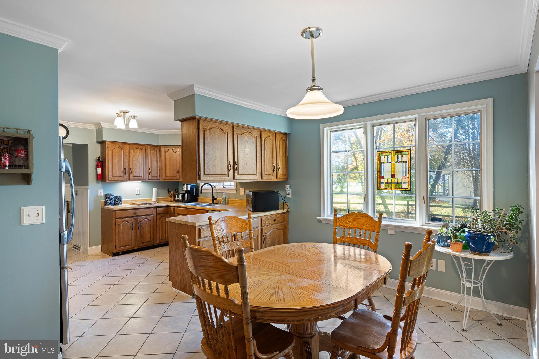 2209 Wheatleys Pond Road Smyrna, DE 19977 - Photo 6 of 39 a dining room with furniture a chandelier and wooden floor