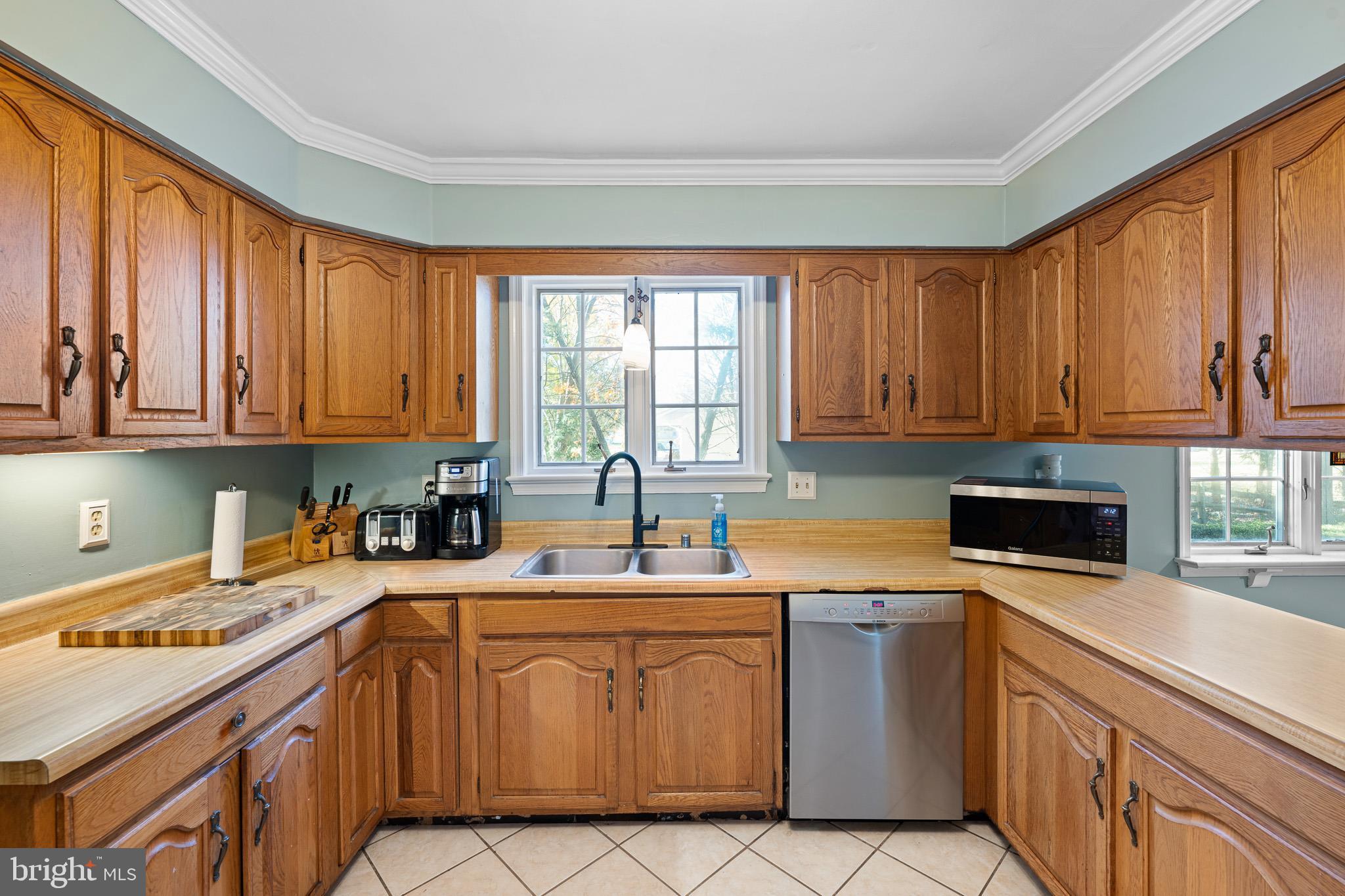 2209 Wheatleys Pond Road Smyrna, DE 19977 - Photo 8 of 39 a kitchen with stainless steel appliances a sink a stove a refrigerator cabinets and a window
