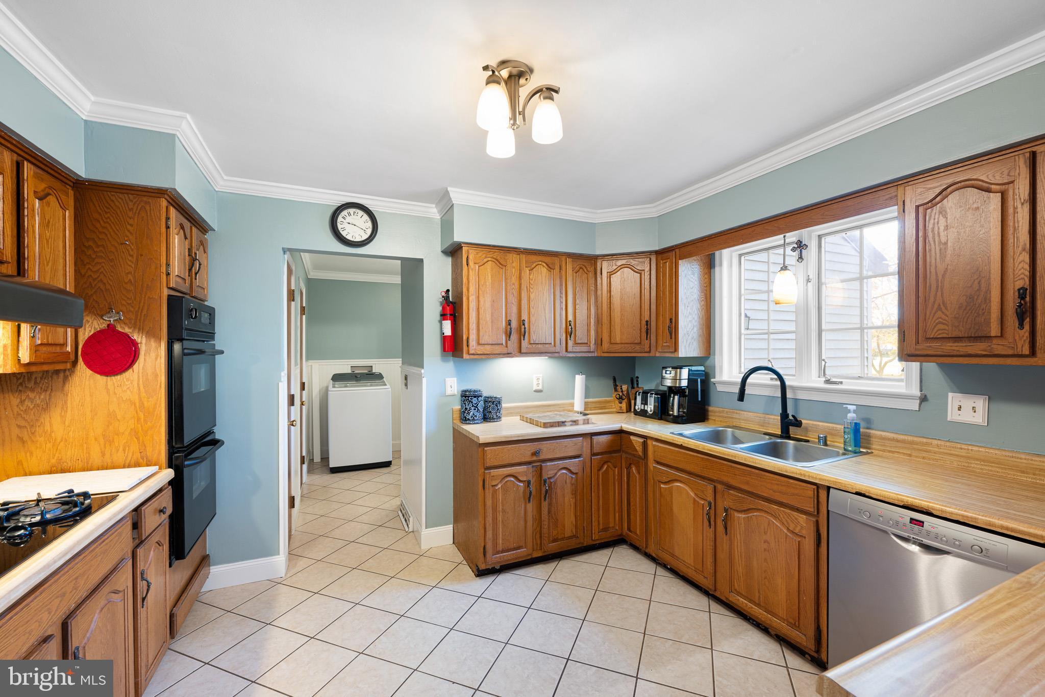 2209 Wheatleys Pond Road Smyrna, DE 19977 - Photo 9 of 39 a kitchen with a sink cabinets and window