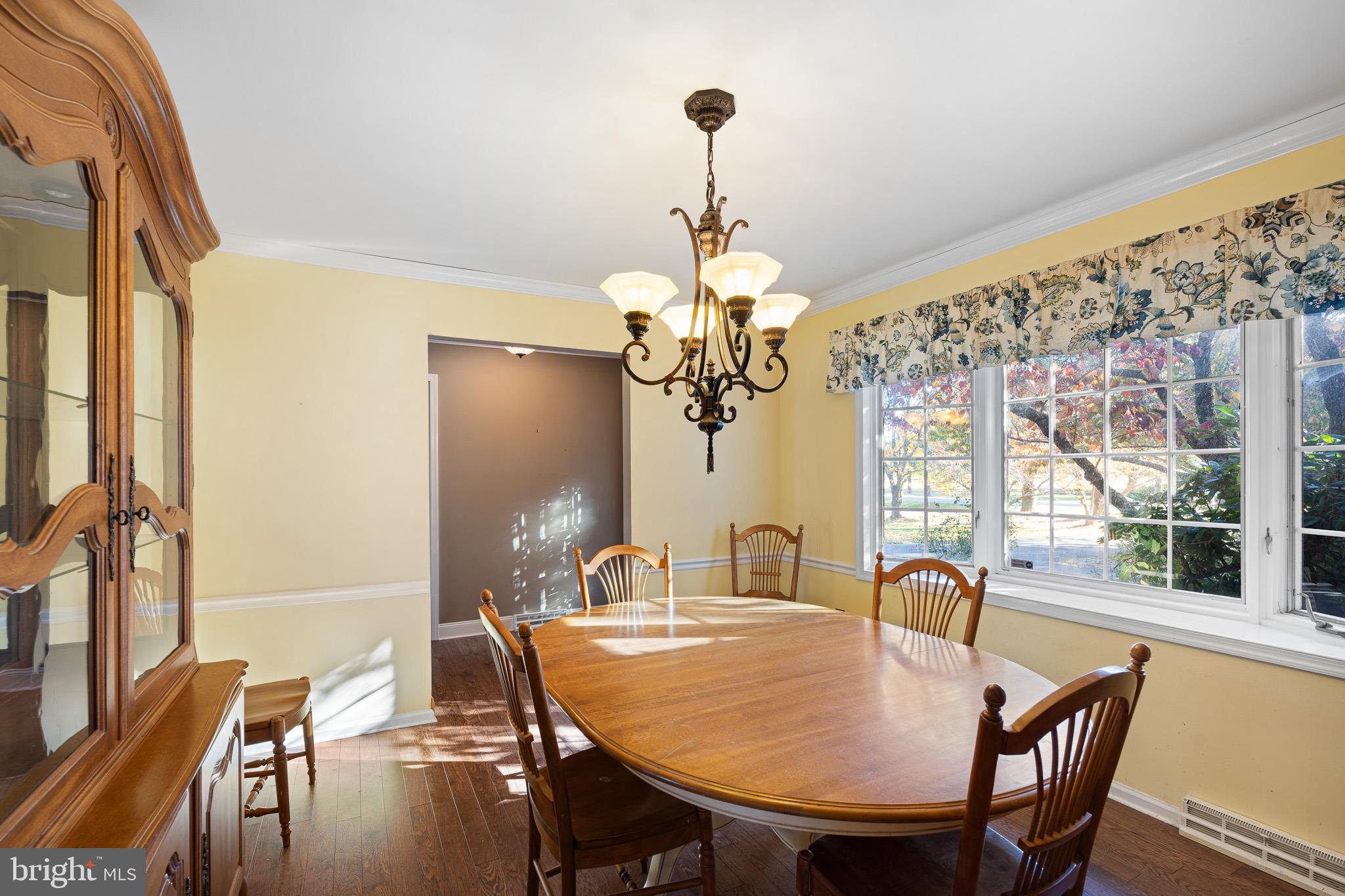 2209 Wheatleys Pond Road Smyrna, DE 19977 - Photo 10 of 39 a dining room with furniture a chandelier and window