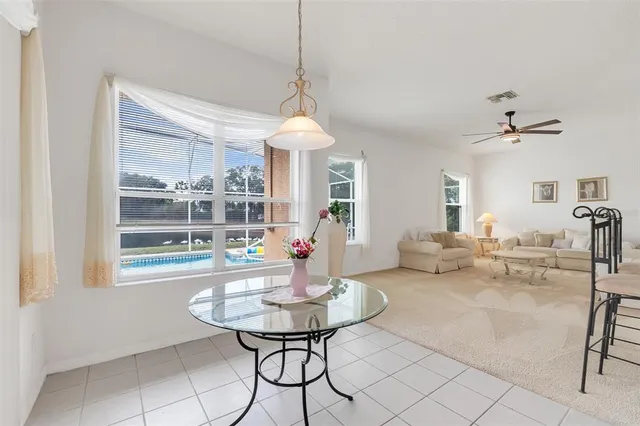 a living room with furniture a table and a chandelier