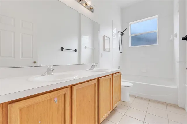 a bathroom with a granite countertop sink a toilet and bathtub