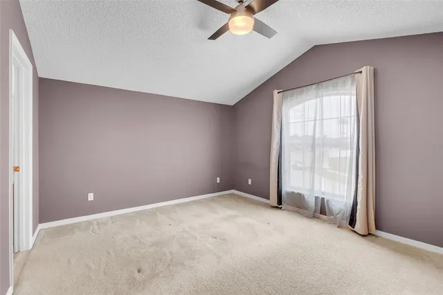 an empty room with a empty space and windows