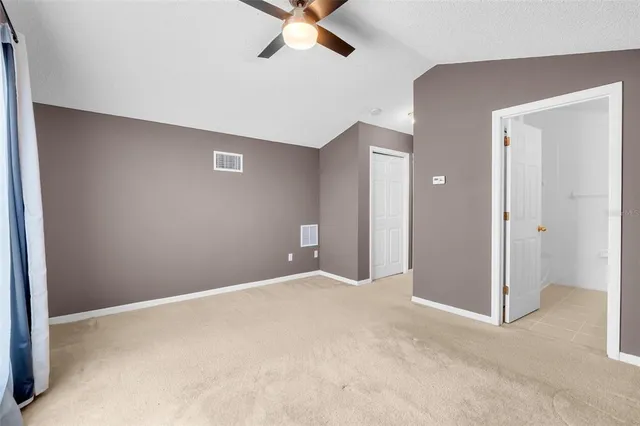 a view of an empty room with a ceiling fan