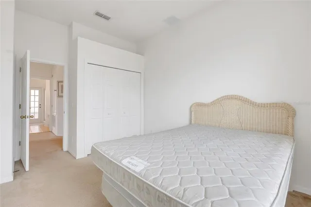 a large white bed in a white room