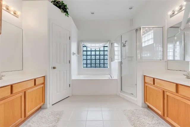 a bathroom with a tub sink and mirror