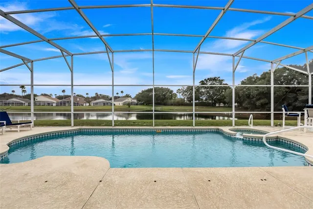 a view of a living room with a floor to ceiling window and pool