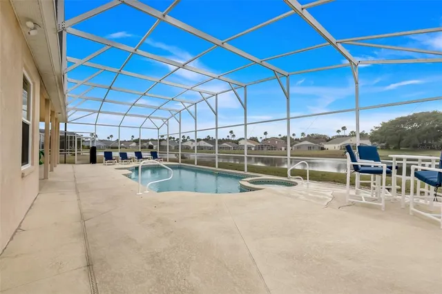 a view of a swimming pool with outdoor seating