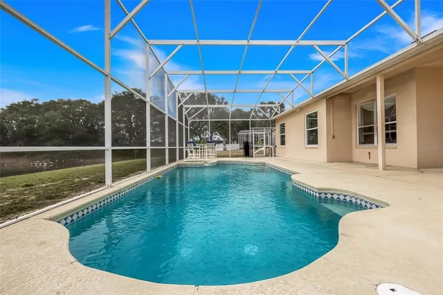 a view of a backyard with swimming pool