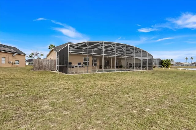 a view of a house with a backyard