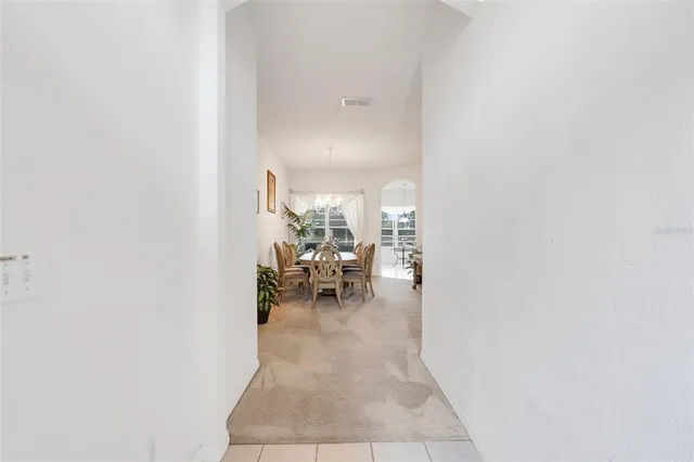 a view of a living room with a table and chairs