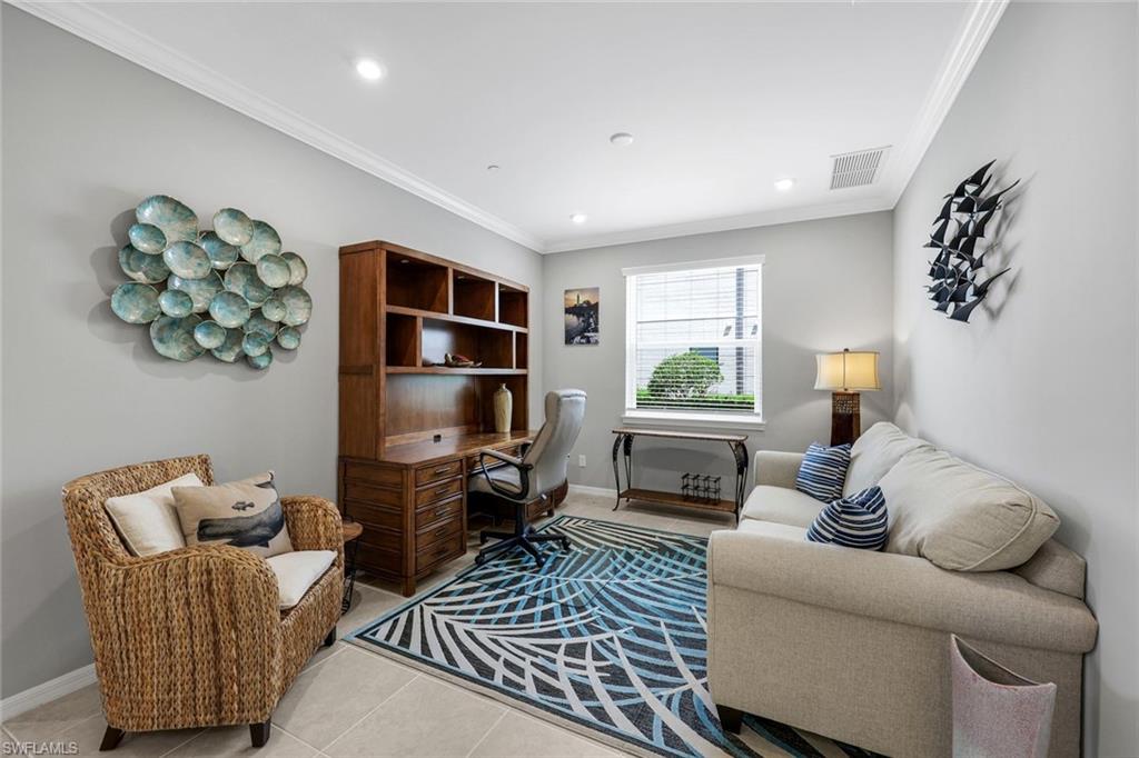 9393 Pocida Court, Unit 104 Naples, FL 34119 - Photo 13 of 28 a living room with furniture and a window
