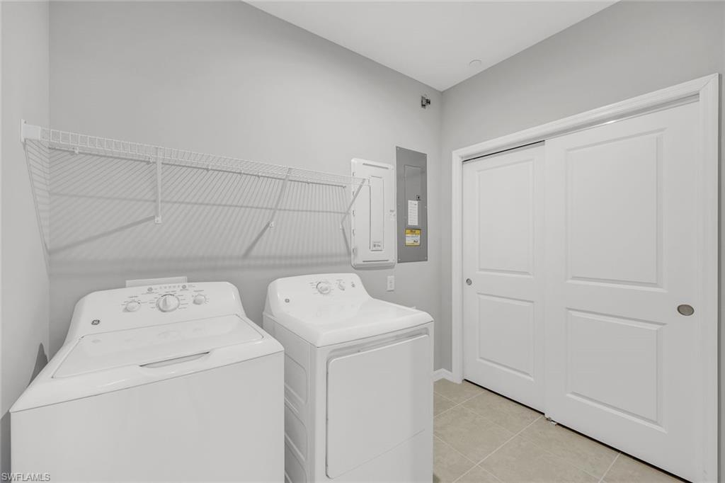 9393 Pocida Court, Unit 104 Naples, FL 34119 - Photo 16 of 28 a utility room with dryer and washer