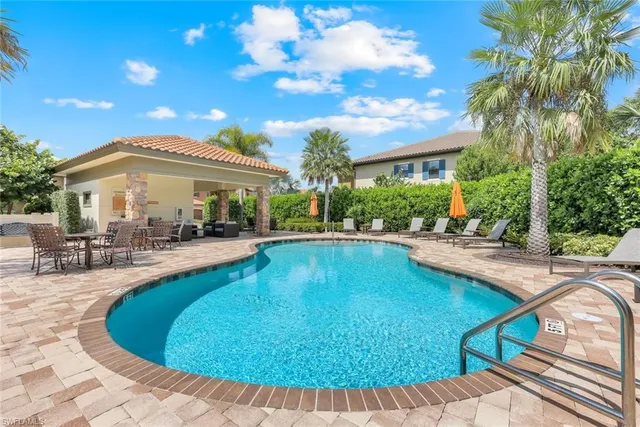 a view of a house with swimming pool and sitting area