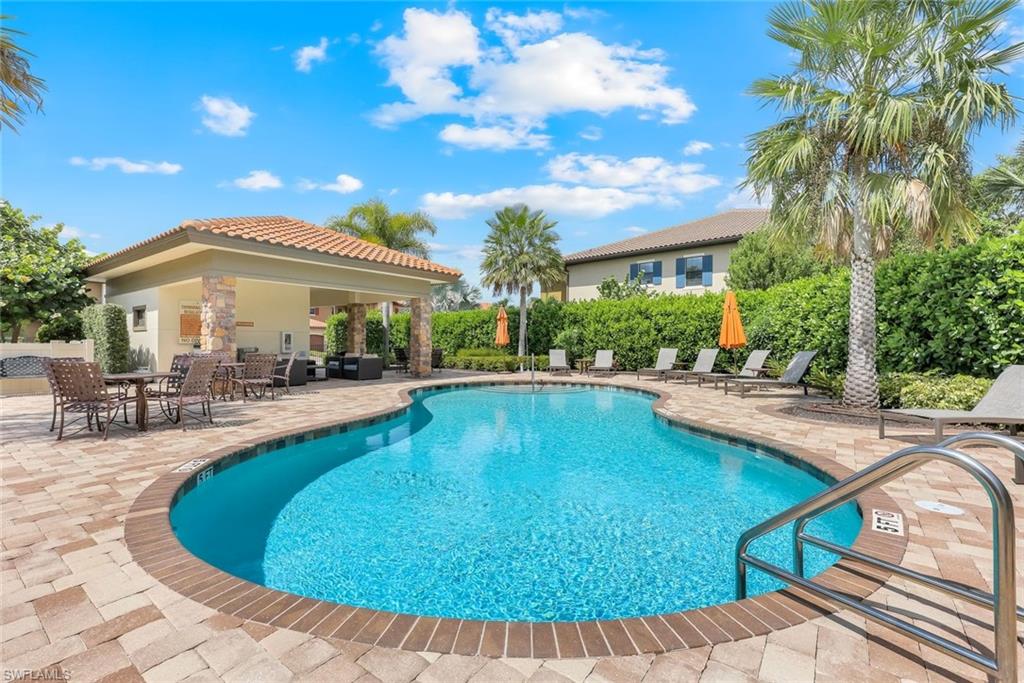 9393 Pocida Court, Unit 104 Naples, FL 34119 - Photo 19 of 28 a view of a house with swimming pool and sitting area