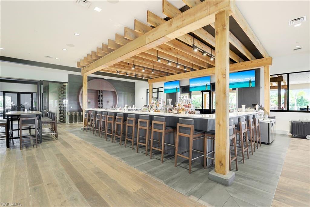 9393 Pocida Court, Unit 104 Naples, FL 34119 - Photo 24 of 28 a view of a room with lots of wooden furniture