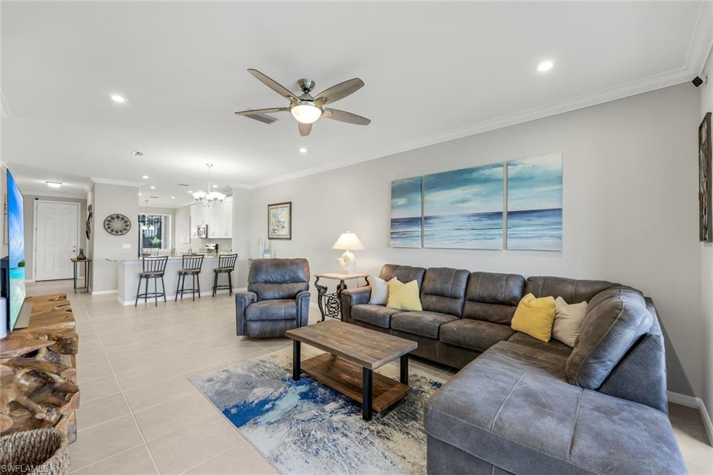 9393 Pocida Court, Unit 104 Naples, FL 34119 - Photo 3 of 28 a living room with furniture and a window