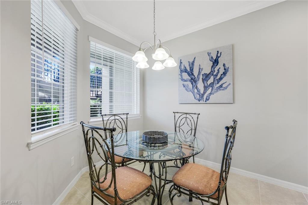 9393 Pocida Court, Unit 104 Naples, FL 34119 - Photo 9 of 28 a view of a dining room with furniture window and outside view