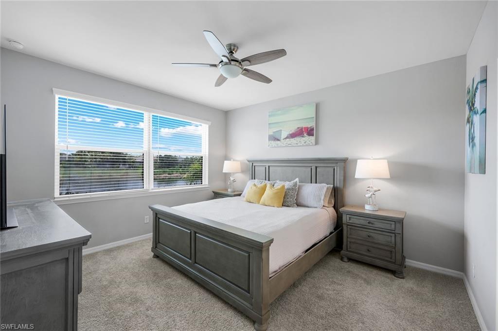 9393 Pocida Court, Unit 104 Naples, FL 34119 - Photo 10 of 28 a bedroom with a bed and a window