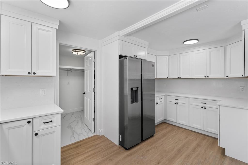 66 River Court Naples, FL 34110 - Photo 14 of 29 a kitchen with stainless steel appliances a refrigerator and cabinets