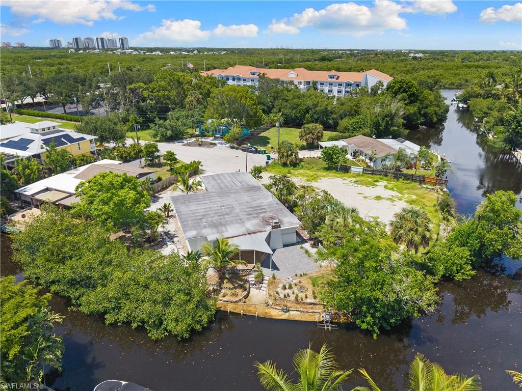 66 River Court Naples, FL 34110 - Photo 26 of 29 an aerial view of a city with lots of residential buildings ocean and mountain view in back
