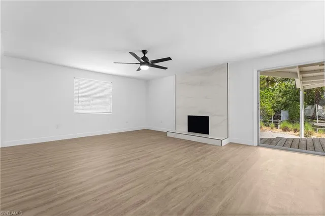 wooden floor in an empty room with a fireplace