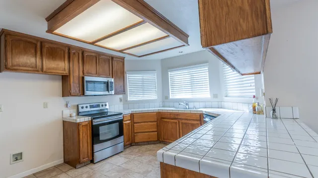 a kitchen with a sink and a stove top oven