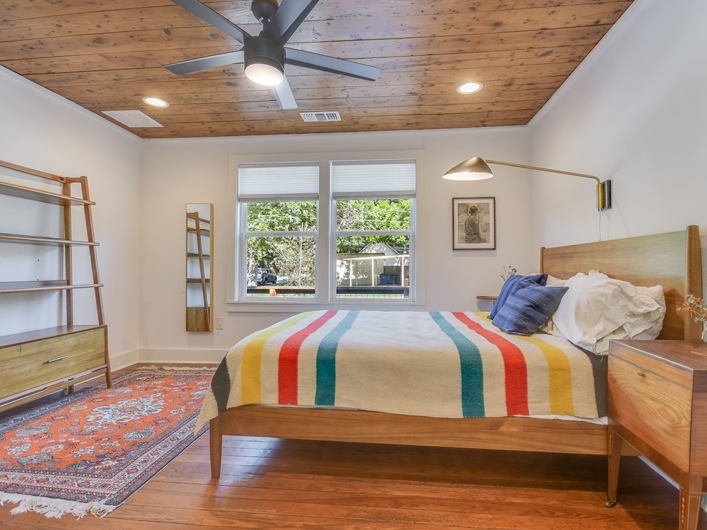 1313 Garden Street Austin, TX 78702 - Photo 12 of 23 a bedroom with a large bed and a large window