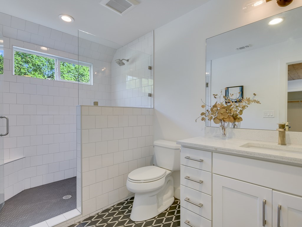 1313 Garden Street Austin, TX 78702 - Photo 13 of 23 a bathroom with a sink a toilet and a shower