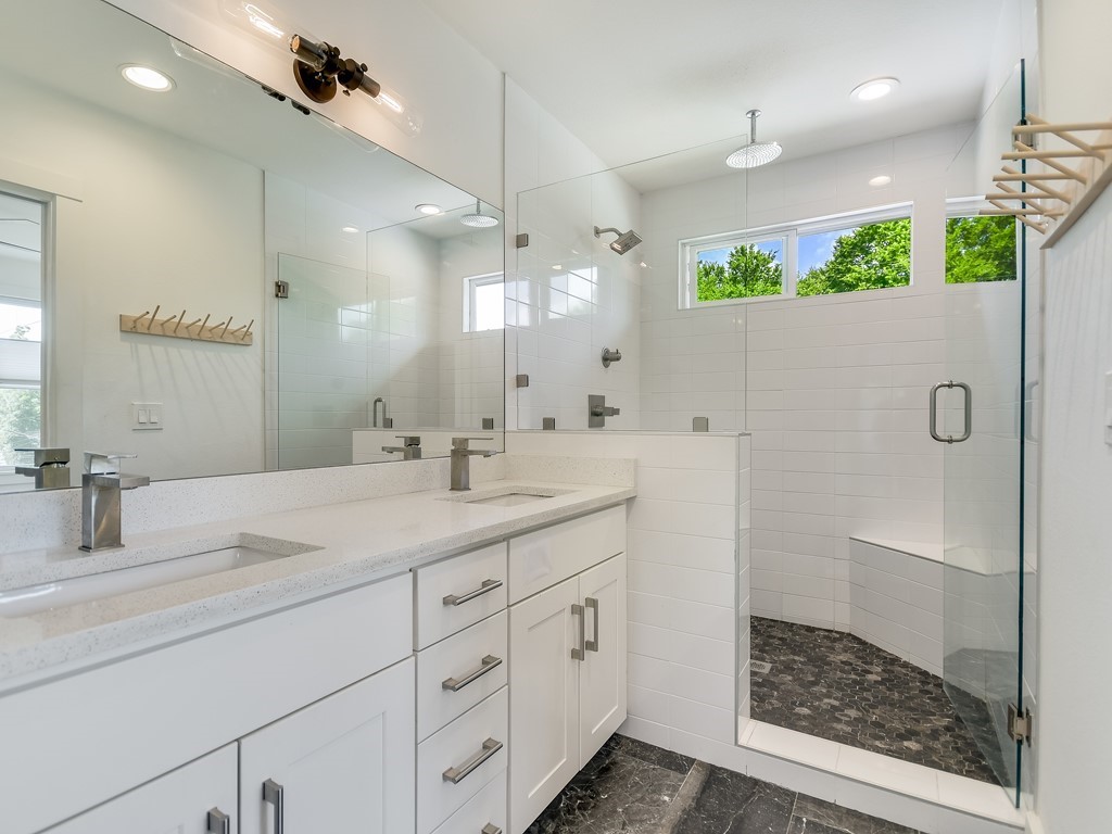 1313 Garden Street Austin, TX 78702 - Photo 17 of 23 a bathroom with a double vanity sink mirror and shower