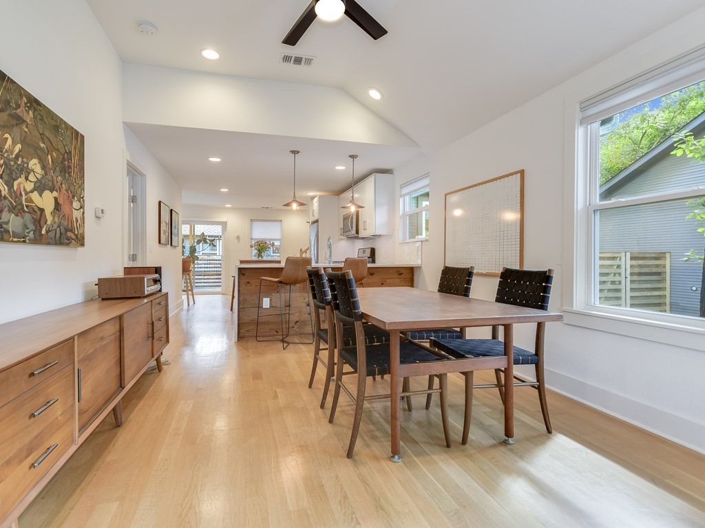 1313 Garden Street Austin, TX 78702 - Photo 4 of 23 a large kitchen with a table and chairs in it