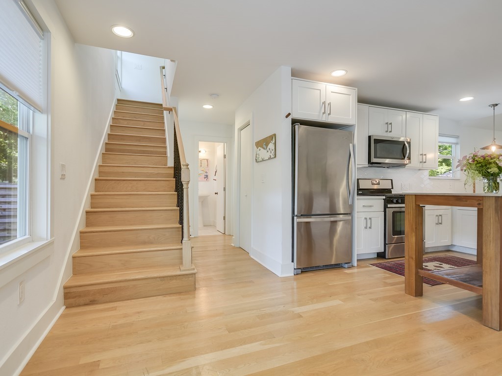 1313 Garden Street Austin, TX 78702 - Photo 10 of 23 a kitchen with granite countertop a refrigerator and a stove top oven