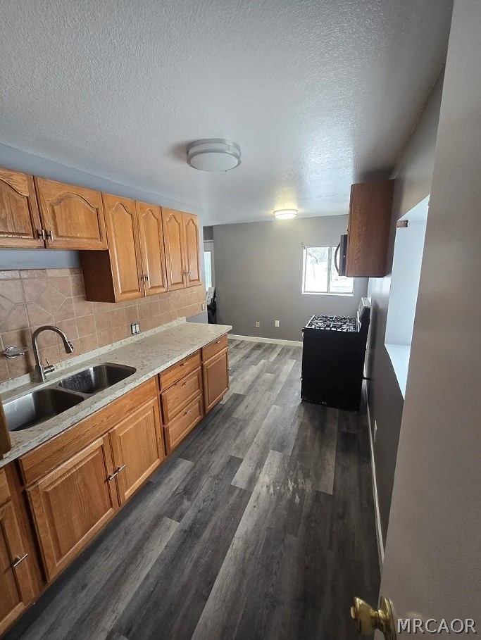 32928 Rim Of The World Highway Running Springs, CA 92382 - Photo 6 of 7 a large kitchen with wooden floors and stainless steel appliances