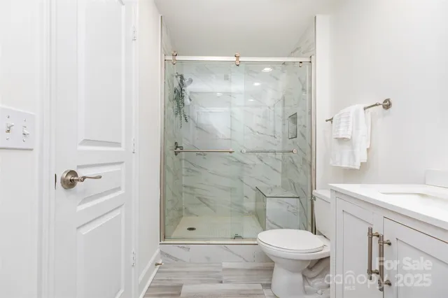 a bathroom with a shower and a toilet