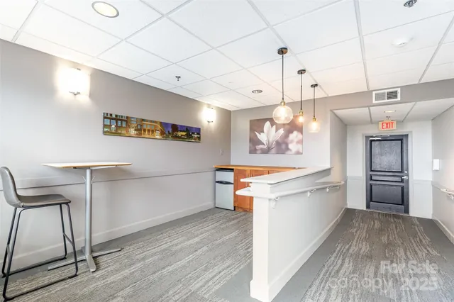 a large kitchen with a wooden floor and stainless steel appliances